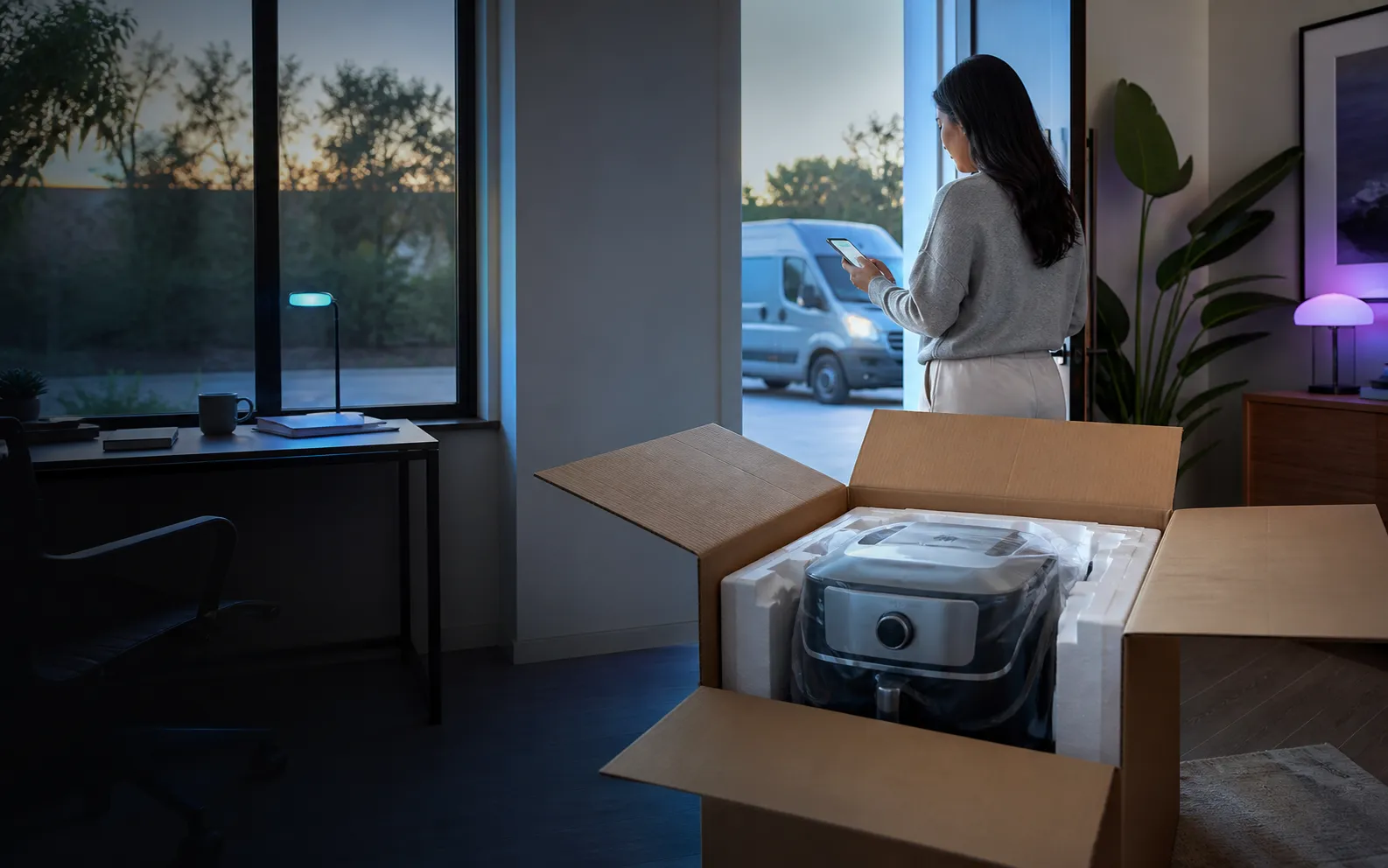 Customer checking a replacement delivery beside an open package in a modern home office